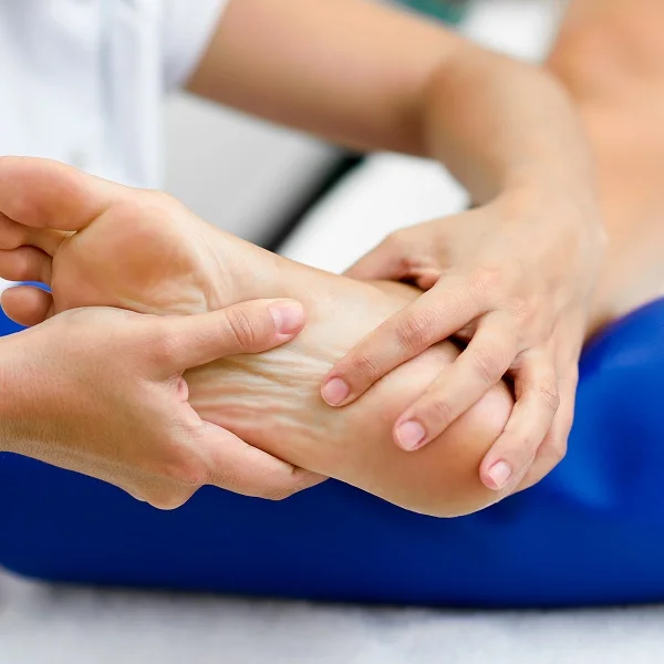 A person relaxing while receiving a soothing foot massage in a calm, serene environment.